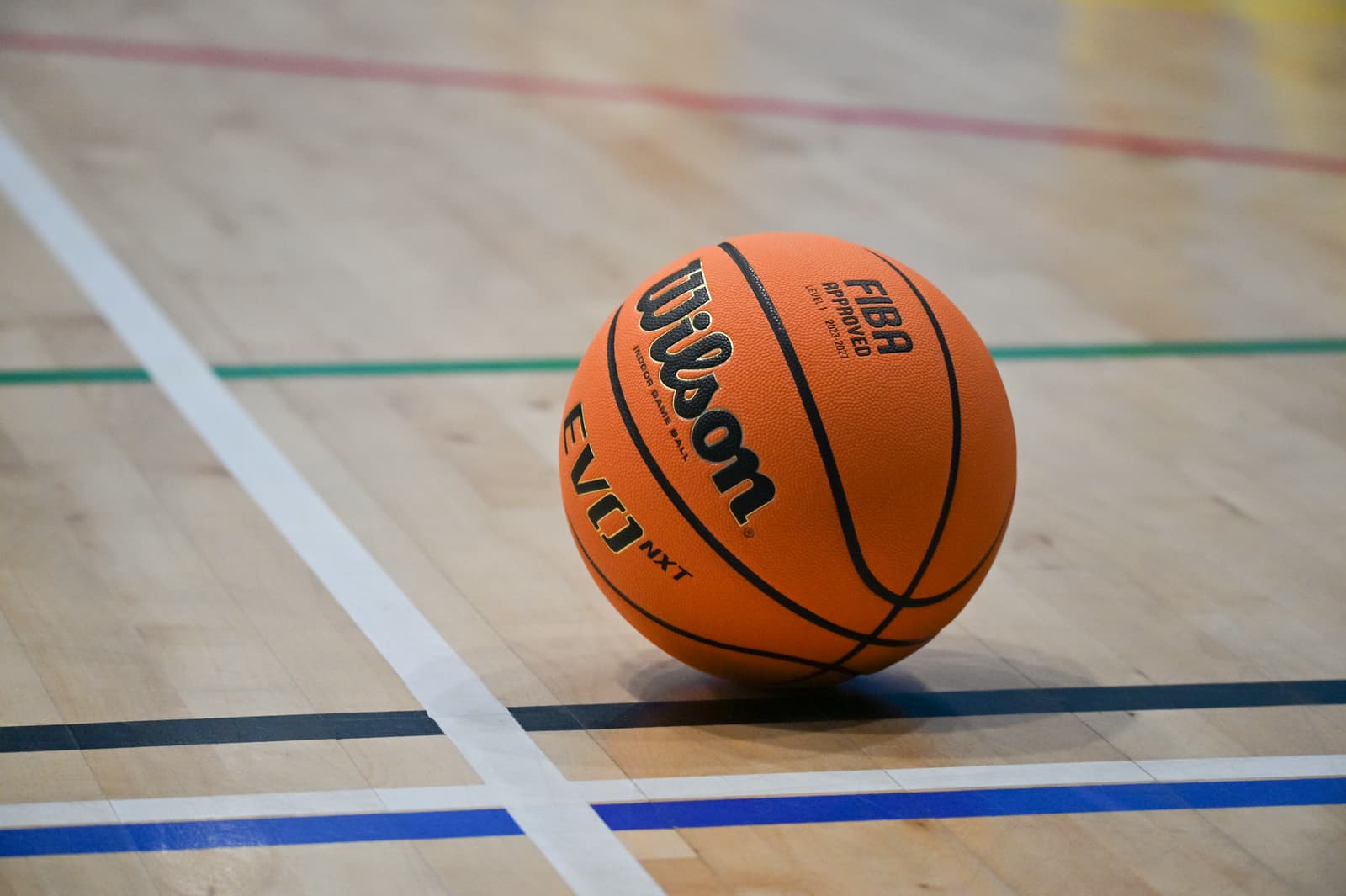 Basketball resting on the indoor court